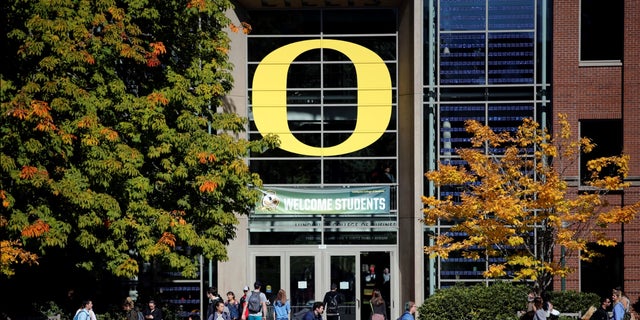University of Oregon students walk across campus in Eugene, Ore.