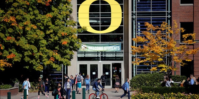 University of Oregon students walk across campus in Eugene, Ore.