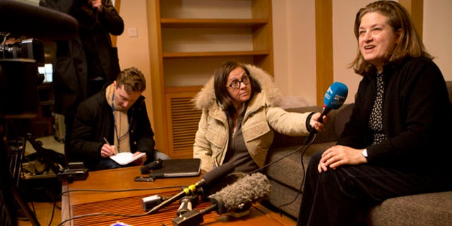 Dec. 31, 2015: French journalist Ursula Gauthier, right, a reporter in China for the French news magazine L'Obs, speaks to the media in her apartment before leaving for the airport in Beijing (AP)
