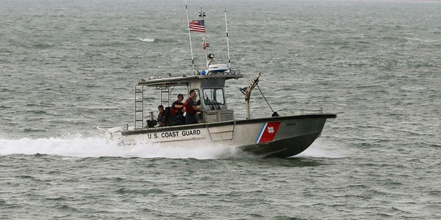 ATLANTIC, VA - OCTOBER 29: A U.S. Coast Guard boat patrols the waters near NASA's Wallops Flight Facility, October 29, 2014 in Atlantic, Virginia. An unmanned Orbital Sciences Corporation Antares commercial rocket headed for the International Space Station to deliver supplies exploded into a massive fireball in the early evening of October 28, seconds after lifting off from the launch pad at NASA's Wallops Island Flight Facility. (Photo by Mark Wilson/Getty Images)