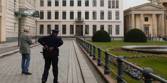 April 16, 2013: In this file photo, United States security officers patrol in front of the U.S. embassy in Berlin, Germany. Germany took the dramatic step Thursday of asking the top U.S. intelligence official in Berlin to leave the country, following two reported cases of suspected U.S. spying and the yearlong spat over eavesdropping by the National Security Agency.