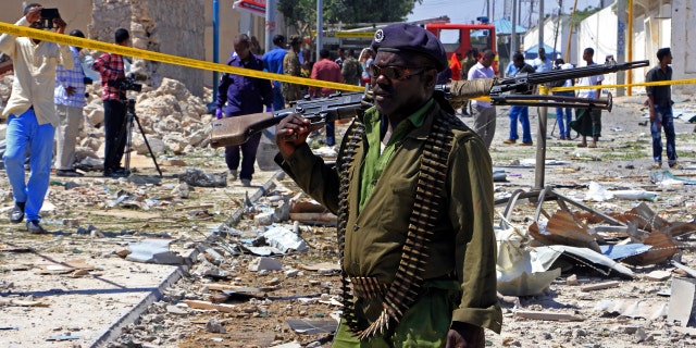 FILE - In this Jan. 2, 2017, file photo, a Somali soldier patrols the area of a suicide car bomb attack in Mogadishu, Somalia.