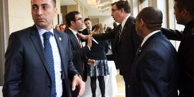 Brookings Institute Vice President and Chief Operating Officer Steve Bennett, center right, before Turkish President Recep Tayyip Erdogan speaks.