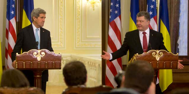 Feb. 5, 2015: Ukrainian President Petro Poroshenko, right, gestures toward U.S. Secretary of State John Kerry during their statement to the media at the Presidential Administration Building in Kiev, Ukraine.