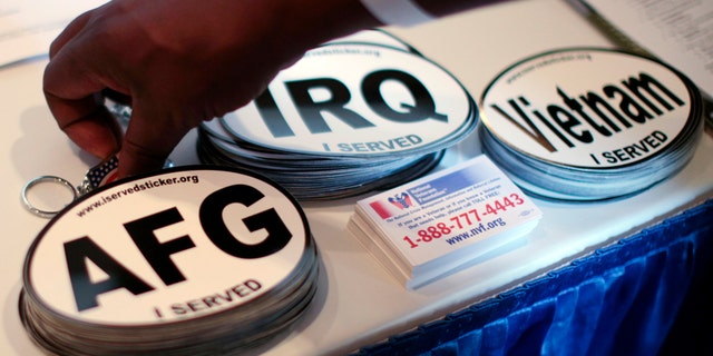 Car stickers commemorating U.S. military service in Vietnam, Afghanistan and Iraq are seen on a recruiter's table at a veterans job fair in Los Angeles, California November 10, 2010. REUTERS/Lucy Nicholson (UNITED STATES - Tags: EMPLOYMENT BUSINESS) - GM1E6BB0KP901