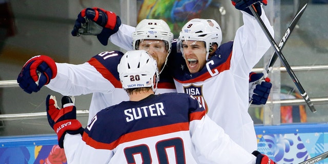 Feb. 19, 2014: USA forward Zach Parise (9) celebrates his goal against the Czech Republic with teammates Phil Kessel (81) and USA defenseman Ryan Suter during the second period of men's quarterfinal hockey game in Shayba Arena at the 2014 Winter Olympics in Sochi, Russia.