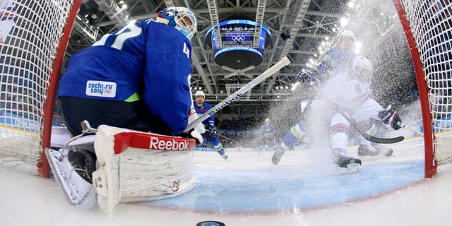 Feb. 16, 2014: Slovenia goaltender Luka Gracnar looks back at the puck after USA forward Phil Kessel scored period of a men's ice hockey game at the 2014 Winter Olympics, Sunday, Feb. 16, 2014, in Sochi, Russia.