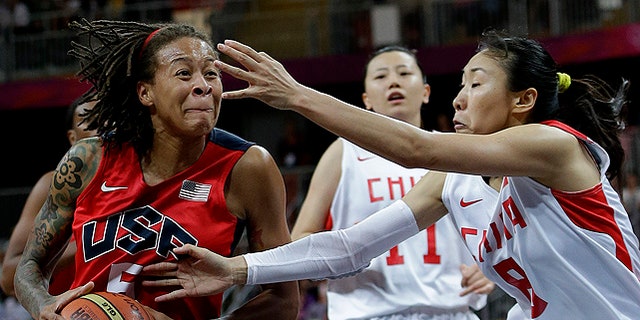Aug. 5: USA's Seimone Augustus, left, drives past China defenders Miao Lijie (8) and Ma Zengyu (11) during a preliminary women's basketball game at the 2012 Summer Olympics. Team USA will meet France on Saturday for a chance to take home gold. (AP)
