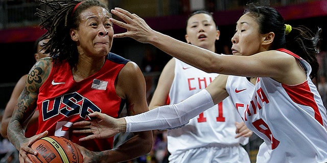 Aug. 5: USA's Seimone Augustus, left, drives past China defenders Miao Lijie (8) and Ma Zengyu (11) during a preliminary women's basketball game at the 2012 Summer Olympics. Team USA will meet France on Saturday for a chance to take home gold. (AP)