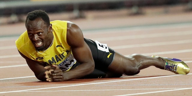 Jamaica's Usain Bolt lies on the track after he injured himself during the 4x100 m relay final during the World Athletics Championships in London Saturday.