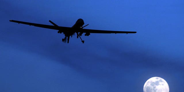 In this Jan. 31, 2010 file photo, an unmanned U.S. Predator drone flies over Kandahar Air Field, southern Afghanistan, on a moon-lit night.