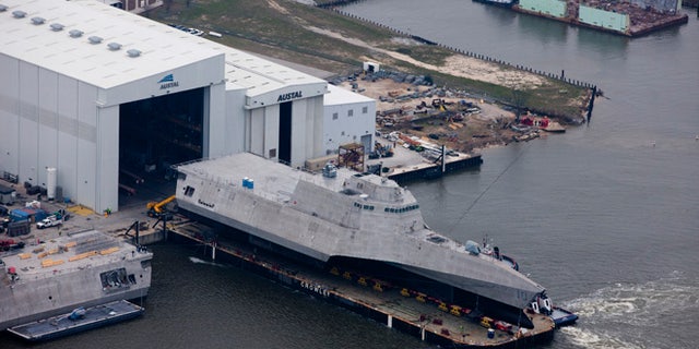 An aerial view of the future littoral combat ship USS Gabrielle Giffords (LCS 10) during its launch sequence at the Austal USA shipyard.