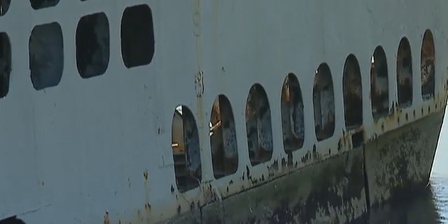 The vessel, which weighs 25,000 tons when submerged, is rusting and rotting in a river that is now filled with thick silt and only 3-feet deep at low tide.