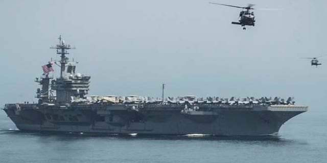 Helicopters fly from the aircraft carrier USS Theodore Roosevelt, which is headed to the Korean Peninsula.