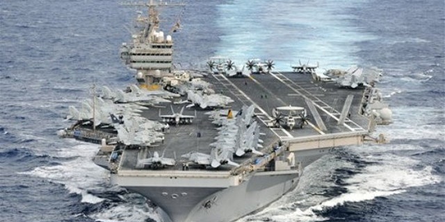 In this photo taken Dec. 16, 2011 and released by U.S. Navy, its aircraft carrier USS Abraham Lincoln (CVN 72) transits through the Pacific Ocean.