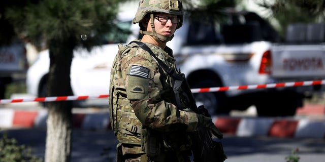Sept. 16, 2014: A U.S. solider stands guard at the site of a suicide attack near a U.S. military camp in Kabul, Afghanistan. (AP)