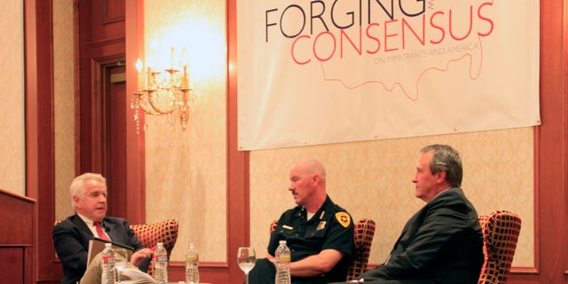 Doug Wright (left), a Utah radio show host, moderates a panel with Salt Lake City Police Chief Chris Burbank (middle), and Utah Attorney General Mark Shurtleff (right), as they discuss the effects that an enforcement-only immigration policy would have on police.