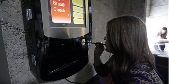 Feb. 14, 2014: Zest's special events manager Lindsy Wing demonstrates their breathalyzer at Zest Kitchen & Bar in Salt Lake City.