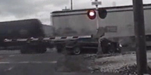 Oct. 15, 2013: Authorities say a woman who was trying to evade police was injured when the car she was driving crashed into a train and then was struck by a second train.
