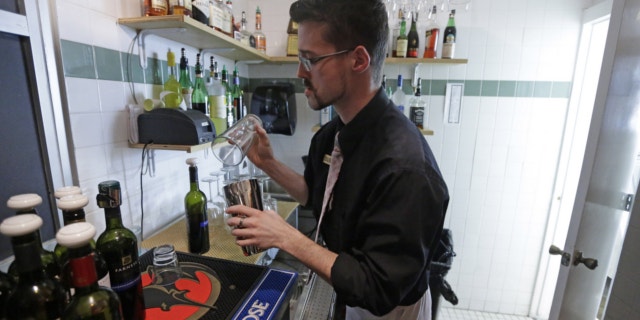 FILE: Feb. 26, 2013: Manager Dustin Humes fixes a drink in a small room which is out of the view of patrons at Vivace Restaurant, in Salt Lake City.