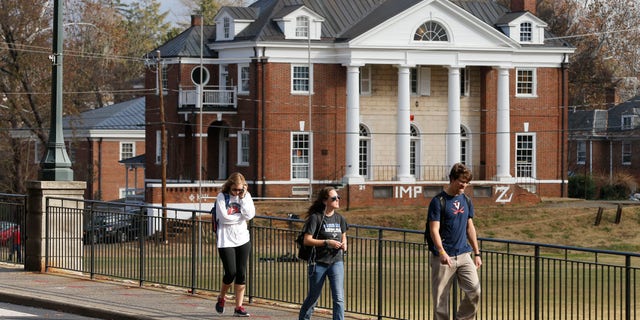 Nov. 24, 2014: University of Virginia students walk to campus past the Phi Kappa Psi fraternity house at the University of Virginia