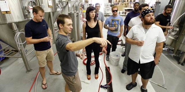 Aug. 20, 2012: Hardywood Park Craft Brewery President and co-founder, Eric McKay, second from left, and brewmaster Patrick Murtaugh, left, talk to a tour group.