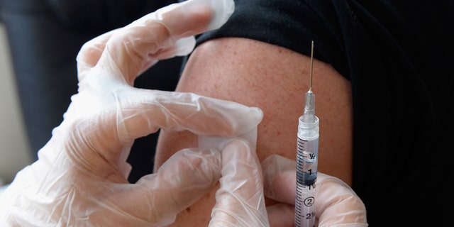 HOLLYWOOD, CA - APRIL 15: People receive a free meningitis vaccine from Dr. Wayne Chen at the AIDS Healthcare Foundation pharmacy on April 15, 2013 in Hollywood, California. The AIDS Healthcare Foundation started free meningitis vaccines after a West Hollywood man died from the disease. (Photo by Kevork Djansezian/Getty Images)