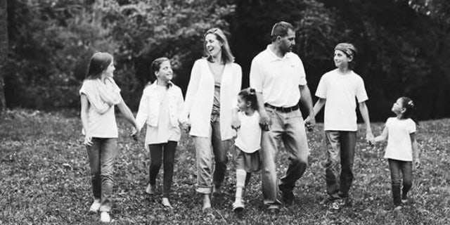 Kim Vaillancourt, center, and her husband Phil, right, had just adopted three girls and found out they were expecting when Kim was diagnosed with grade 4 glioblastoma.