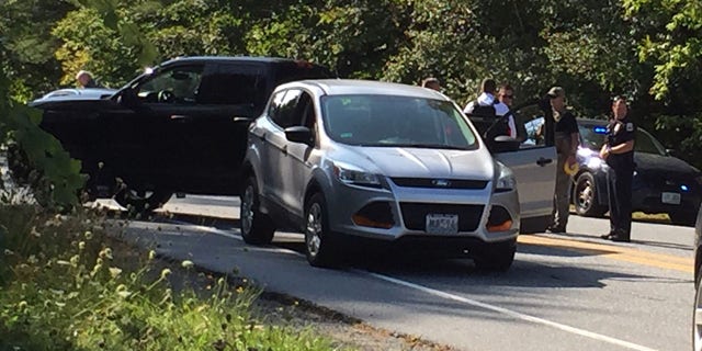 Police surround the suspect's vehicle near Dartmouth-Hitchcock Medical Center in Lebanon, N.H.