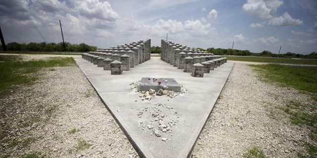 HOLD FOR STORY BY JENNIFER KAY- In this June 25, 2014 file photo, the ValuJet Memorial is seen in the Florida Everglades in  Everglades National Park. ValuJet Flight 592 crashed while trying to make an emergency return to Miami on May 11,1996, killing all 110 people on board. Relatives of the victims of Flight 592 will meet in the Florida Everglades to mark the 20th anniversary. (AP Photo/J. Pat Carter, File)