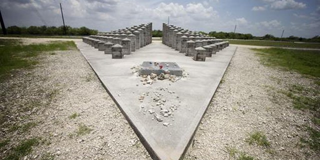 HOLD FOR STORY BY JENNIFER KAY- In this June 25, 2014 file photo, the ValuJet Memorial is seen in the Florida Everglades in Everglades National Park. ValuJet Flight 592 crashed while trying to make an emergency return to Miami on May 11,1996, killing all 110 people on board. Relatives of the victims of Flight 592 will meet in the Florida Everglades to mark the 20th anniversary. (AP Photo/J. Pat Carter, File)