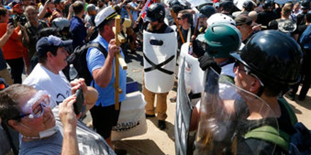Counter demonstrators photograph white supremacists at the entrance to Emancipation Park in Charlottesville, Va., on Aug. 12, 2017.