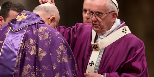 Feb. 10, 2016: Pope Francis places ashes on the head of Cardinal Tarcisio Bertone during the Ash Wednesday mass, in St. Peter's Basilica at the Vatican. (AP)