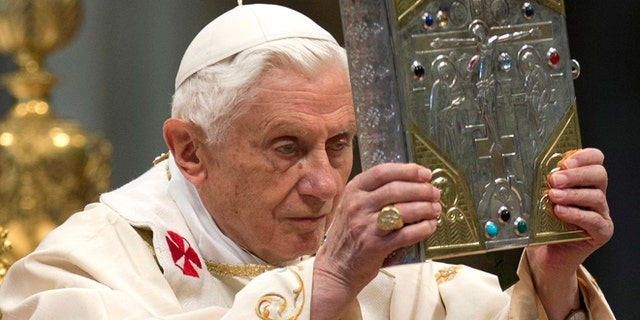 Nov. 25, 2012: Pope Benedict XVI holds the holy Gospel as he celebrates a mass for the newly elected cardinals in St. Peter's Basilica at the Vatican. )