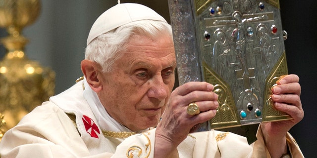 Nov. 25, 2012: Pope Benedict XVI holds the holy Gospel as he celebrates a mass for the newly elected cardinals in St. Peter's Basilica at the Vatican. )