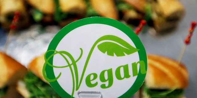 File 2017: A sticker with the word vegan is seen near sandwiches in Toulouse, France. A British chef is receiving backlash after claiming to have put additional non-essential ingredients to a vegan diner's dish on Saturday night.