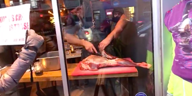 A chef at Toronto's Antler Kitchen and Bar responded to a demonstration outside his eatery by slicing up a piece of meat in full view of protesters.