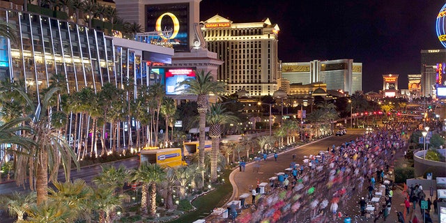 In this Dec. 4, 2011 file photo, runners stream southward on Las Vegas Boulevard during the Rock 'n Roll Las Vegas Marathon in Las Vegas.