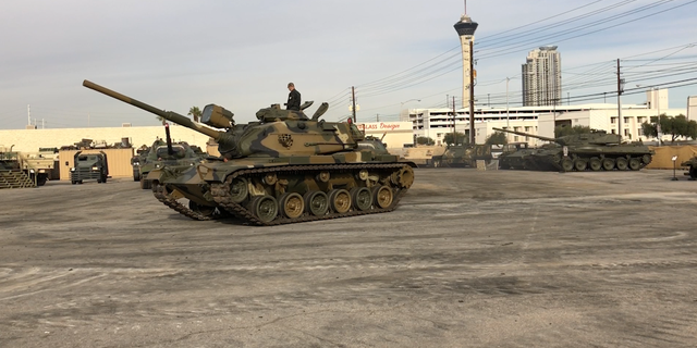 A tank drives in the lot of Battlefield Vegas