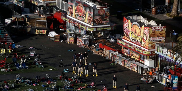 Investigators work at a festival grounds across the street from the Mandalay Bay Resort and Casino on Tuesday, Oct. 3, 2017, in Las Vegas. Authorities said Stephen Craig Paddock broke windows on the casino and began firing with a cache of weapons, killing dozens and injuring hundreds at the music festival on Sunday.