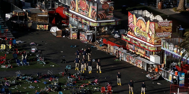 Investigators work at a festival grounds across the street from the Mandalay Bay Resort and Casino on Tuesday, Oct. 3, 2017, in Las Vegas. Authorities said Stephen Craig Paddock broke windows on the casino and began firing with a cache of weapons, killing dozens and injuring hundreds at the music festival on Sunday.