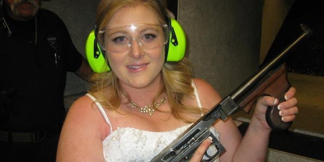 July 28, 2012: Lindsae MacDuff holds an automatic weapon at the Gun store in Las Vegas after her "shotgun wedding."