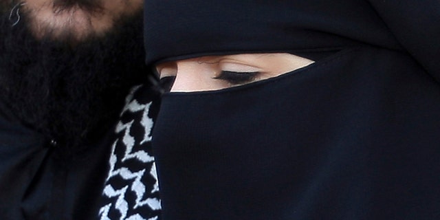 April 23, 2010: Lies Hebbadj, left, and his wife Sandrine Mouleres , speak to reporters in Nantes, western France. A French court on Dec. 12 annulled a fine given to a woman driver wearing an Islamic face veil before France's nationwide ban on the garments goes into effect. Traffic police in the western city of Nantes had fined 31-year-old Sandrine Mouleres in April, saying she did not have a clear field of vision. The fine was just $29, but drew widespread attention amid nationwide debate over the place of Islamic veils in today's France. (AP)