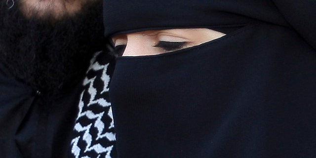 April 23, 2010: Lies Hebbadj, left, and his wife Sandrine Mouleres , speak to reporters in Nantes, western France. A French court on Dec. 12 annulled a fine given to a woman driver wearing an Islamic face veil before France's nationwide ban on the garments goes into effect. Traffic police in the western city of Nantes had fined 31-year-old Sandrine Mouleres in April, saying she did not have a clear field of vision. The fine was just $29, but drew widespread attention amid nationwide debate over the place of Islamic veils in today's France. (AP)