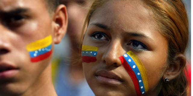 CARACAS, VENEZUELA - DECEMBER 19: Young supporters of Venezuelan President Hugo Chavez listen to a speech as they attend a rally December 19, 2002 in Caracas, Venezuela. The country is in the 18th day of a nationwide strike which has crippled Venezuela's vital oil industry. (Photo by Paula Bronstein/Getty Images)