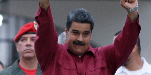 Venezuela's President Nicolas Maduro raises his fists after voting in presidential elections in Caracas, Venezuela, Sunday, May 20, 2018. Amidst hyperinflation and shortages of food and medicine Maduro is seeking a second six-year term in an election that a growing chorus of foreign governments refuse to recognize after key opponents were barred from running. (AP Photo/Ricardo Mazalan)