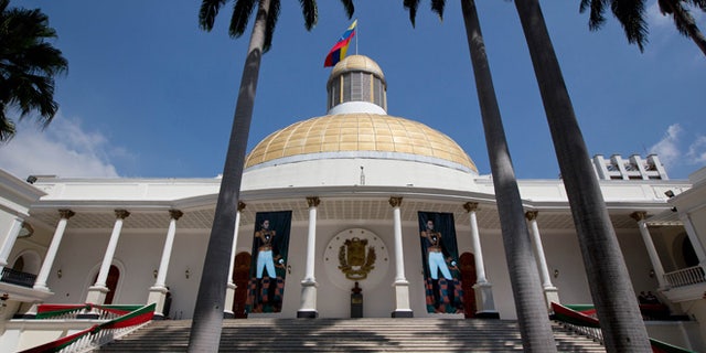 Paintings of Venezuelan independence hero Simon Bolivar decorate the stairs of the National Assembly building in Caracas, Venezuela, Monday, Jan. 11, 2016. Venezuela's Supreme Court has ordered the country's new opposition congress to unseat three barred lawmakers and is declaring that any action the body takes in the meantime is null. The court published a decision Monday that said the congress' acts would be void while the three lawmakers were seated. (AP Photo/Fernando Llano)