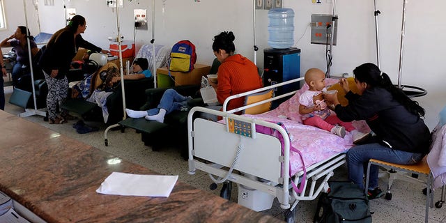 A mother feeds her child donated soup at the J.M. de los Rios Children Hospital in Caracas, Feb. 22, 2017.