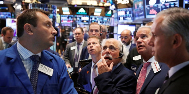 Traders work on the floor of the New York Stock Exchange (NYSE) shortly after the opening bell in New York, U.S., August 30, 2016. REUTERS/Lucas Jackson/File Photo - RTX2ORXH