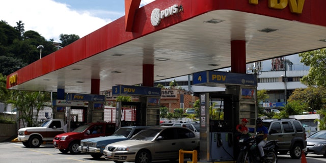 Cars repost fuel at a PDVSA gas station in Caracas, Venezuela, July 25, 2017.